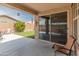 An open patio with comfortable seating, sliding glass door entry and a view of the backyard at 14166 W Valentine St, Surprise, AZ 85379
