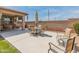An outdoor patio with an umbrella-shaded dining set and seating, creating an inviting space for relaxation at 14166 W Valentine St, Surprise, AZ 85379
