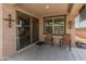 A covered patio featuring sliding glass doors, accent decor, and cozy seating, perfect for relaxation at 14166 W Valentine St, Surprise, AZ 85379