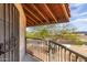 Balcony view with metal railings, desert landscape, and an open-beamed ceiling, offering a serene outdoor space at 16402 N 31St St # 232, Phoenix, AZ 85032