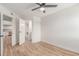 Bright bedroom featuring a ceiling fan, light wood flooring and access to the bathroom and galley kitchen at 16402 N 31St St # 232, Phoenix, AZ 85032
