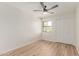 This bedroom has wood-look floors, a ceiling fan, and a window with a view at 16402 N 31St St # 232, Phoenix, AZ 85032