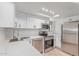 This updated kitchen has stainless appliances, light countertops, and white cabinets at 16402 N 31St St # 232, Phoenix, AZ 85032