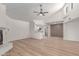 Spacious living room featuring a vaulted ceiling, light wood floors, fireplace and an open kitchen layout at 16402 N 31St St # 232, Phoenix, AZ 85032