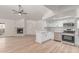 Spacious living room features an open concept kitchen with white cabinets and stainless steel appliances at 16402 N 31St St # 232, Phoenix, AZ 85032
