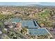 A bird's eye view of multiple tennis courts in a community with beautiful landscaping and a backdrop of mountains at 16945 W Vernon Ave, Goodyear, AZ 85395