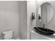 Elegant powder room featuring modern fixtures, a stylish sink, and tasteful decor at 16945 W Vernon Ave, Goodyear, AZ 85395