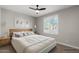 Comfortable bedroom features lots of natural light, a ceiling fan and natural decor at 16945 W Vernon Ave, Goodyear, AZ 85395