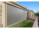 Exterior view of the covered patio featuring sunshades, turf, and brick pavers at 16945 W Vernon Ave, Goodyear, AZ 85395
