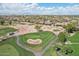 Stunning aerial view of lush golf course with manicured greens, sand traps, and picturesque landscaping at 16945 W Vernon Ave, Goodyear, AZ 85395