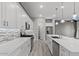 Modern kitchen with white cabinetry, stainless steel appliances, subway tile backsplash, and a large central island at 16945 W Vernon Ave, Goodyear, AZ 85395