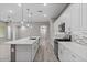 Bright kitchen features a spacious island, stainless steel appliances, and sleek white cabinetry at 16945 W Vernon Ave, Goodyear, AZ 85395
