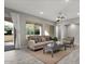 Bright living room featuring neutral tones, stylish furniture, contemporary ceiling fan, and access to the outdoor space at 16945 W Vernon Ave, Goodyear, AZ 85395