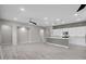 Open-concept living area with tile flooring, recessed lighting, and seamless flow into the kitchen at 16945 W Vernon Ave, Goodyear, AZ 85395