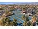 Aerial view of multiple pickleball courts lined with palm trees and players in a vibrant community at 16945 W Vernon Ave, Goodyear, AZ 85395