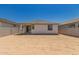 View of the house's rear, showcasing a spacious backyard with potential for landscaping and outdoor activities at 16996 W Fetlock Trl, Surprise, AZ 85387