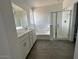 Spacious bathroom features double vanity sinks, a soaking tub, and a glass-enclosed shower at 16996 W Fetlock Trl, Surprise, AZ 85387