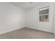 Empty bedroom with neutral carpet, white walls, and a window offering natural light at 16996 W Fetlock Trl, Surprise, AZ 85387
