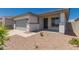 A single-story home showcasing desert landscaping and a neutral color palette at 16996 W Fetlock Trl, Surprise, AZ 85387