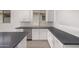 Modern kitchen with stainless steel appliances and gray tile flooring at 16996 W Fetlock Trl, Surprise, AZ 85387
