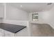 Modern kitchen with white cabinets, dark countertops, and tile backsplash at 16996 W Fetlock Trl, Surprise, AZ 85387