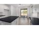 Bright kitchen with island, stainless steel appliances, and white cabinets at 16996 W Fetlock Trl, Surprise, AZ 85387