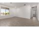 Bright living room with tile flooring, neutral walls, and natural light at 16996 W Fetlock Trl, Surprise, AZ 85387