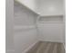 Empty walk-in closet with shelving for storage solutions at 16996 W Fetlock Trl, Surprise, AZ 85387