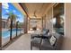 Inviting covered back patio featuring wicker furniture, a ceiling fan, and a stainless steel grill by the pool at 18585 E Ryan Rd, Queen Creek, AZ 85142