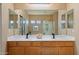 Bathroom featuring double sinks and a vanity mirror at 18585 E Ryan Rd, Queen Creek, AZ 85142