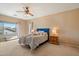 Cozy bedroom featuring a comfortable bed, soft lighting, and a view of the neighborhood at 18585 E Ryan Rd, Queen Creek, AZ 85142