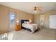 Serene bedroom with neutral tones, soft drapes, and plush carpeting, perfect for restful nights and peaceful mornings at 18585 E Ryan Rd, Queen Creek, AZ 85142