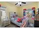 Bedroom featuring a ceiling fan, decorative curtains, and hardwood-style floors at 18585 E Ryan Rd, Queen Creek, AZ 85142