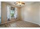 Bedroom featuring a ceiling fan, window, and laminate-style flooring at 18585 E Ryan Rd, Queen Creek, AZ 85142