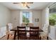 Bright dining room with a large window and an elegant table set for Gathering gatherings and meals at 18585 E Ryan Rd, Queen Creek, AZ 85142