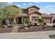 Charming two-story home with manicured desert landscaping, a spacious garage, and a welcoming front entrance at 18585 E Ryan Rd, Queen Creek, AZ 85142