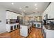 A stylish kitchen boasts an island and modern appliances, perfect for culinary enthusiasts and entertaining at 18585 E Ryan Rd, Queen Creek, AZ 85142