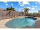 Refreshing backyard pool with decorative tile and safety fence, surrounded by desert landscaping and sunny skies at 18585 E Ryan Rd, Queen Creek, AZ 85142