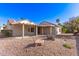 Home featuring a charming backyard with desert landscaping and a covered patio at 19740 N Wind Rose Way, Surprise, AZ 85374