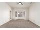 Spacious carpeted bedroom featuring a ceiling fan and a bay window at 19740 N Wind Rose Way, Surprise, AZ 85374