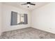 Cozy bedroom featuring neutral walls, carpeting, and a bright window at 19740 N Wind Rose Way, Surprise, AZ 85374