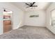 Bedroom with neutral walls, a window, and an entry to the kitchen at 19740 N Wind Rose Way, Surprise, AZ 85374