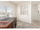 Bedroom featuring neutral walls, plush carpet, and a wooden desk near a window at 19740 N Wind Rose Way, Surprise, AZ 85374