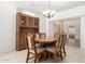 Dining area features a wooden table, cushioned chairs, and a hutch for storage at 19740 N Wind Rose Way, Surprise, AZ 85374