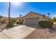 Charming single-story home with desert landscaping, shrubs, cactus and a two-car garage at 19740 N Wind Rose Way, Surprise, AZ 85374