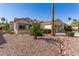 Charming single-story home with desert landscaping including cacti, shrubs, and a two-car garage at 19740 N Wind Rose Way, Surprise, AZ 85374