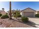 Charming single-story home with a two car garage, desert landscaping, and a neutral color scheme at 19740 N Wind Rose Way, Surprise, AZ 85374