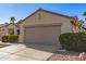 Desert landscaped single-story home with a two car garage and a tile roof on a sunny day at 19740 N Wind Rose Way, Surprise, AZ 85374