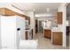 Spacious kitchen with a full appliance suite and an open layout into the dining area and living room at 19740 N Wind Rose Way, Surprise, AZ 85374