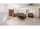 Bright living room featuring tile floors, a ceiling fan, and comfortable seating near the dining area at 19740 N Wind Rose Way, Surprise, AZ 85374